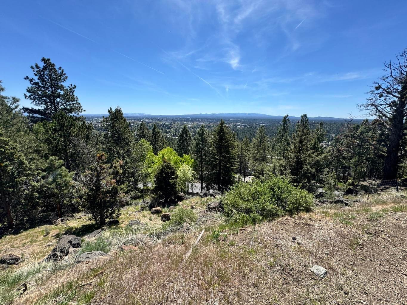 Arguably, some of the best panoramic views of Old Mill District, Pilot Butte, and Downtown Bend from this expansive one-third-acre lot in West Hills.