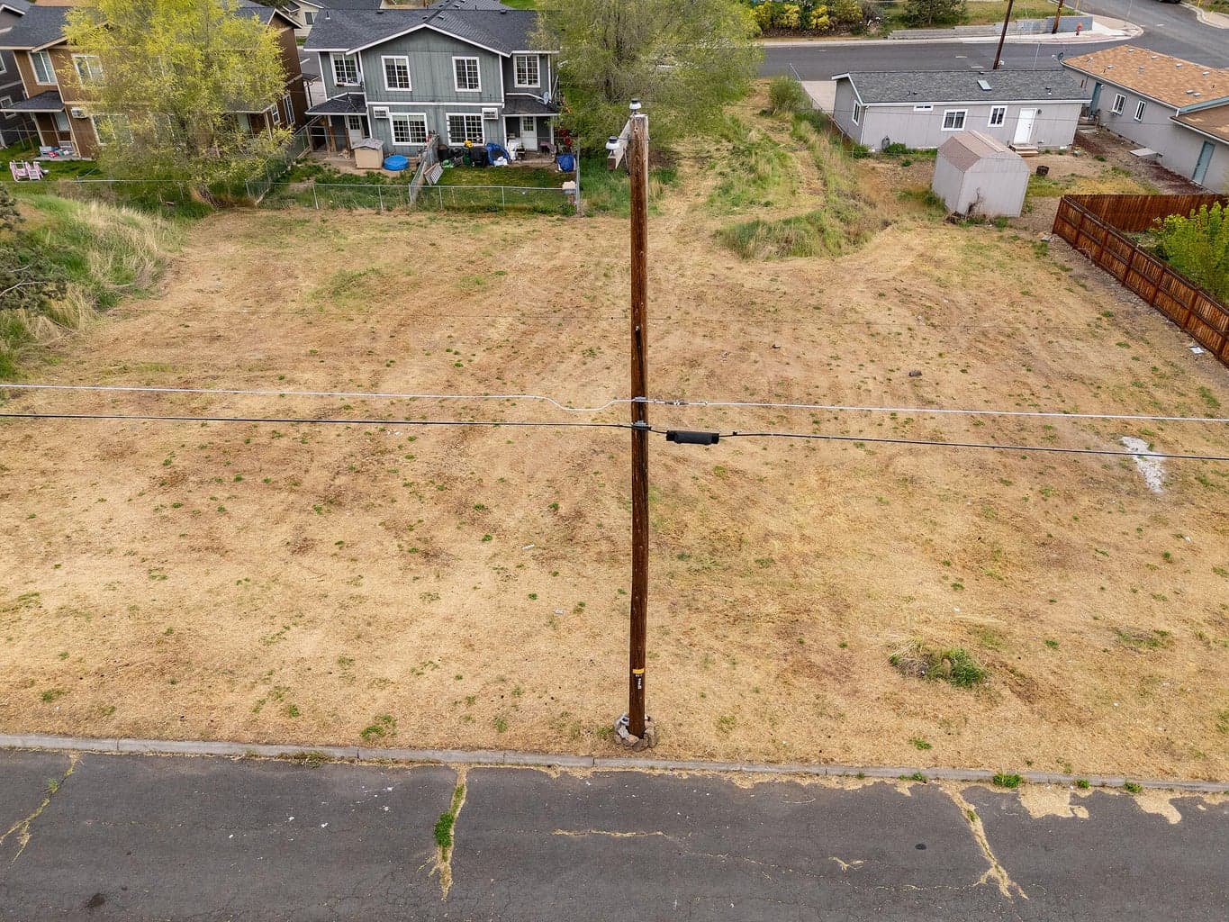 Fairly level cleared lots with curb, paved street, and power pole on the front. City says water and sewer in the street.