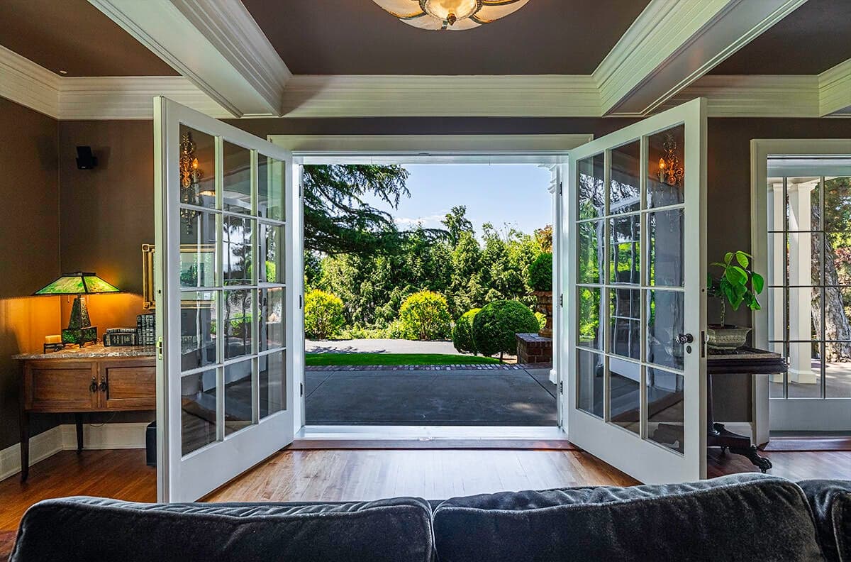 Glass French doors in the formal living room open to the veranda.