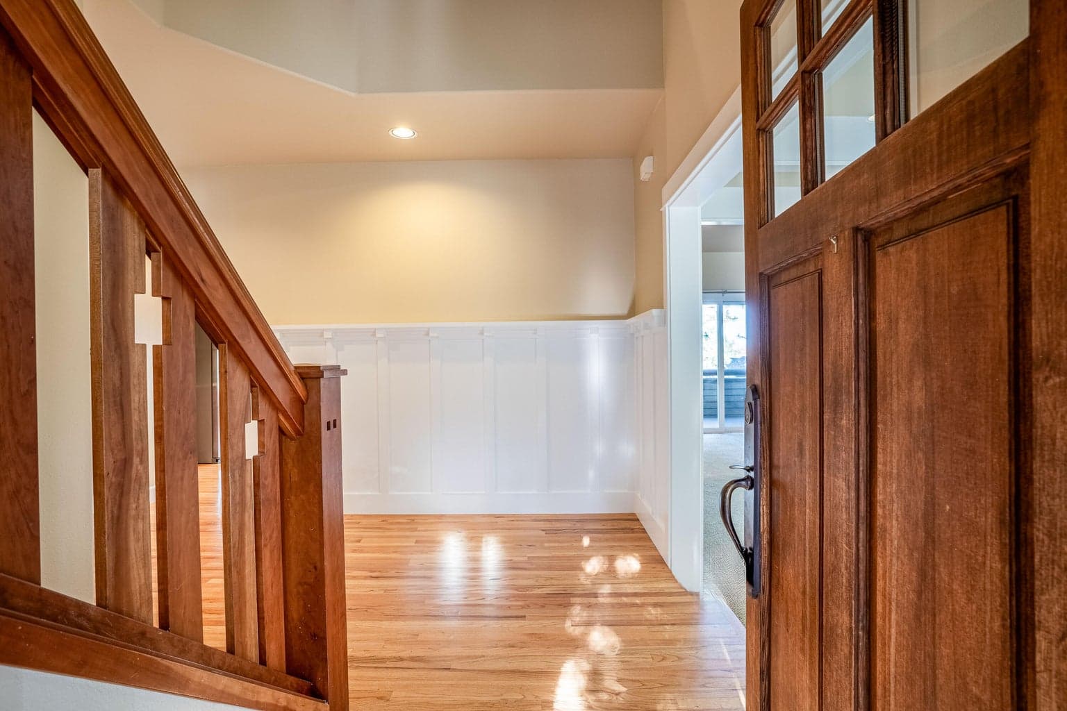 Upon entry, you'll notice the timeless feel of this home with hardwood flooring, wood accents, wainscot and high ceilings.