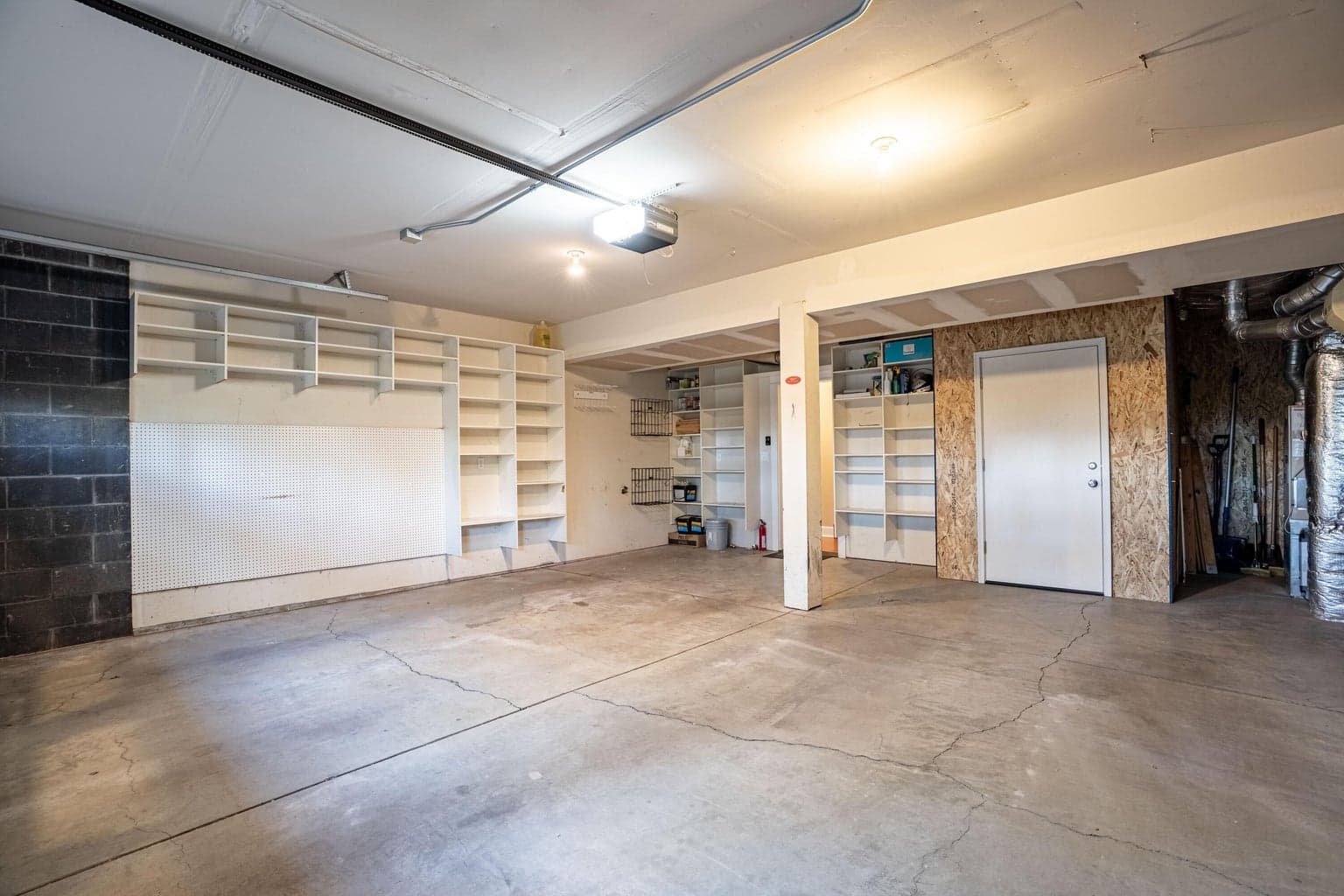 Large 2+ car garage, could be made into a 3 car tandem is you remove the storage room