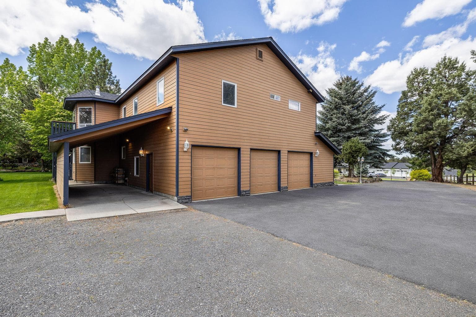 Side view of home 3 car garage and car port.