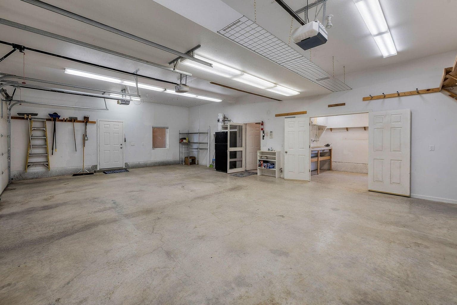 Shop area w/ work bench inside 3 car garage.