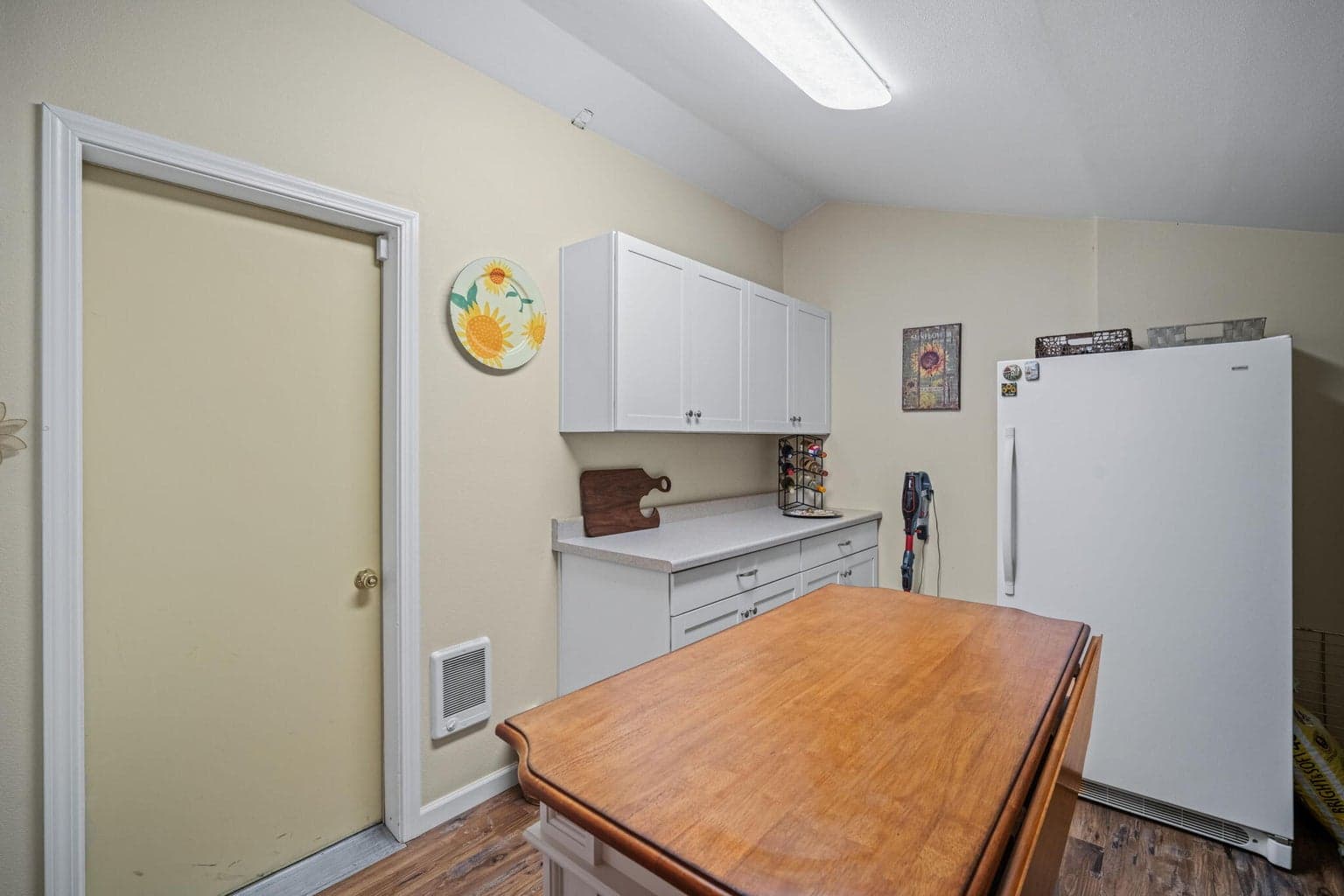 Laundry room. Door to the left is additional storage