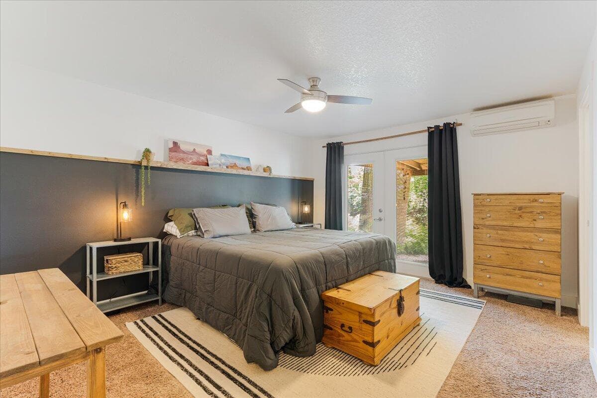 Primary bedroom with access to the rear patio and hot tub.