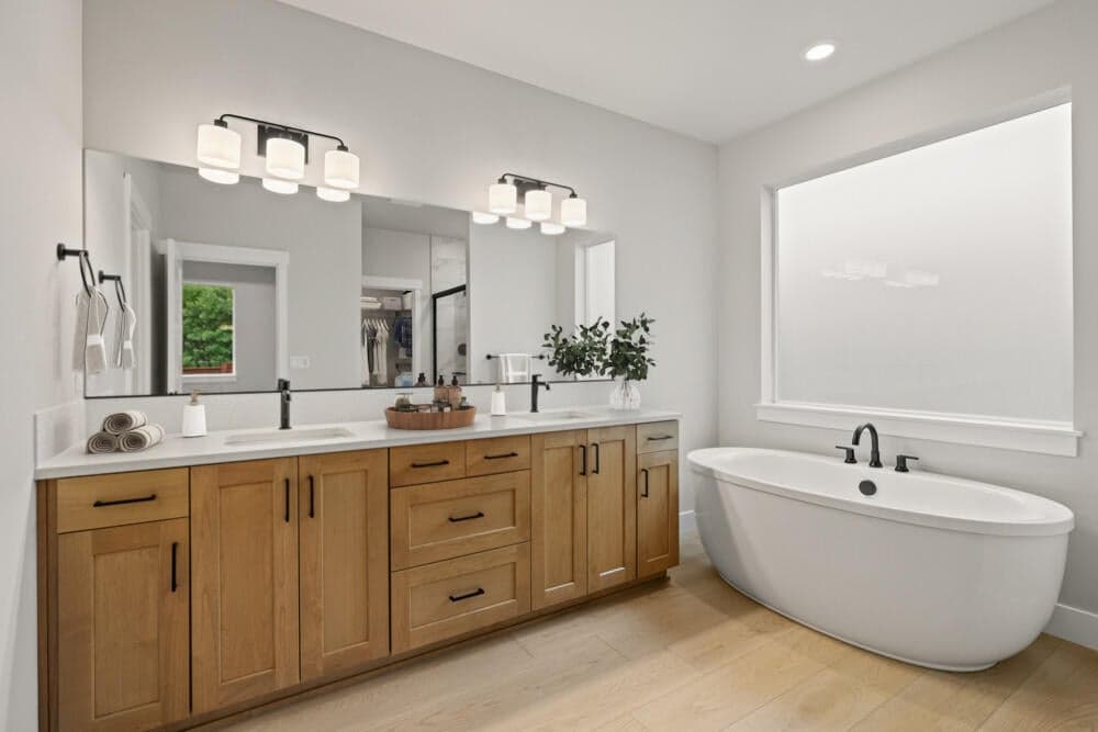 Virtual staging, subject property. Primary suite bath with soaking tub, tile shower, water closet, and large walk-in-closet.