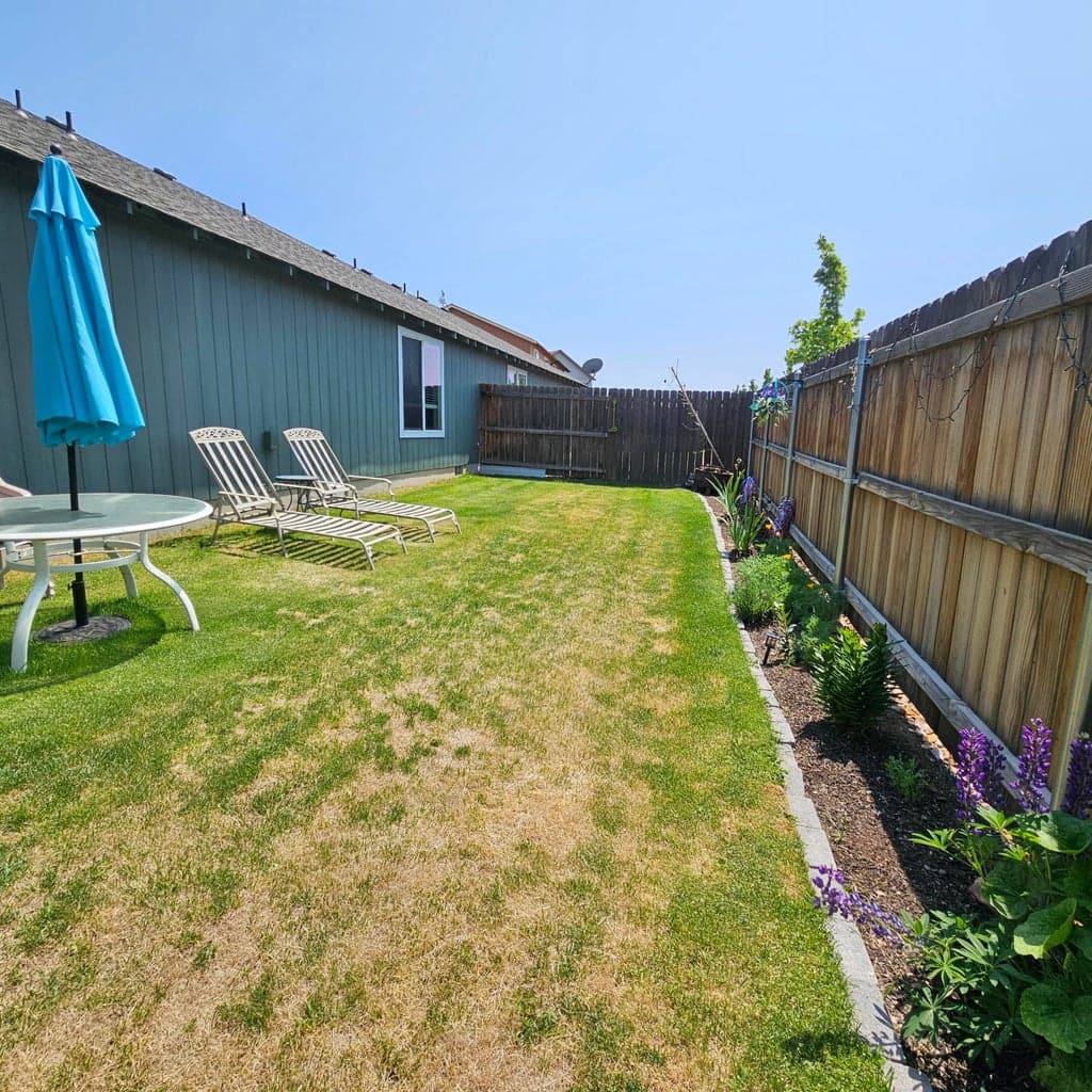 The completely landscaped backyard has room for gardening, fido and friends!