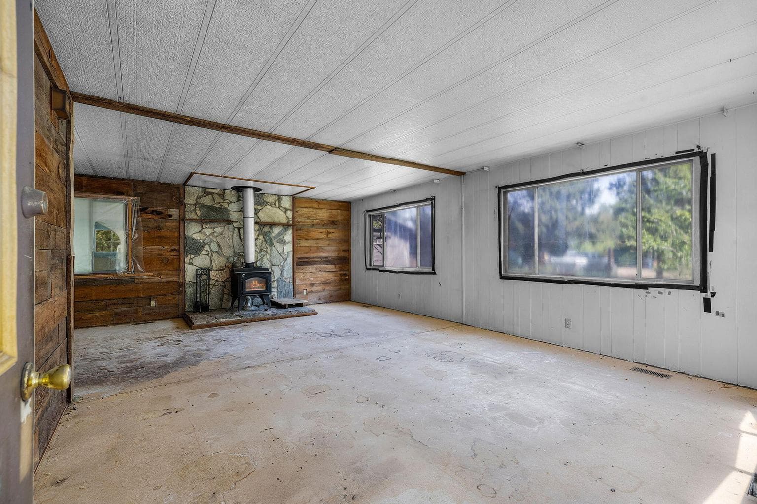 front living with 1 year old wood stove, lots of natural light, and space