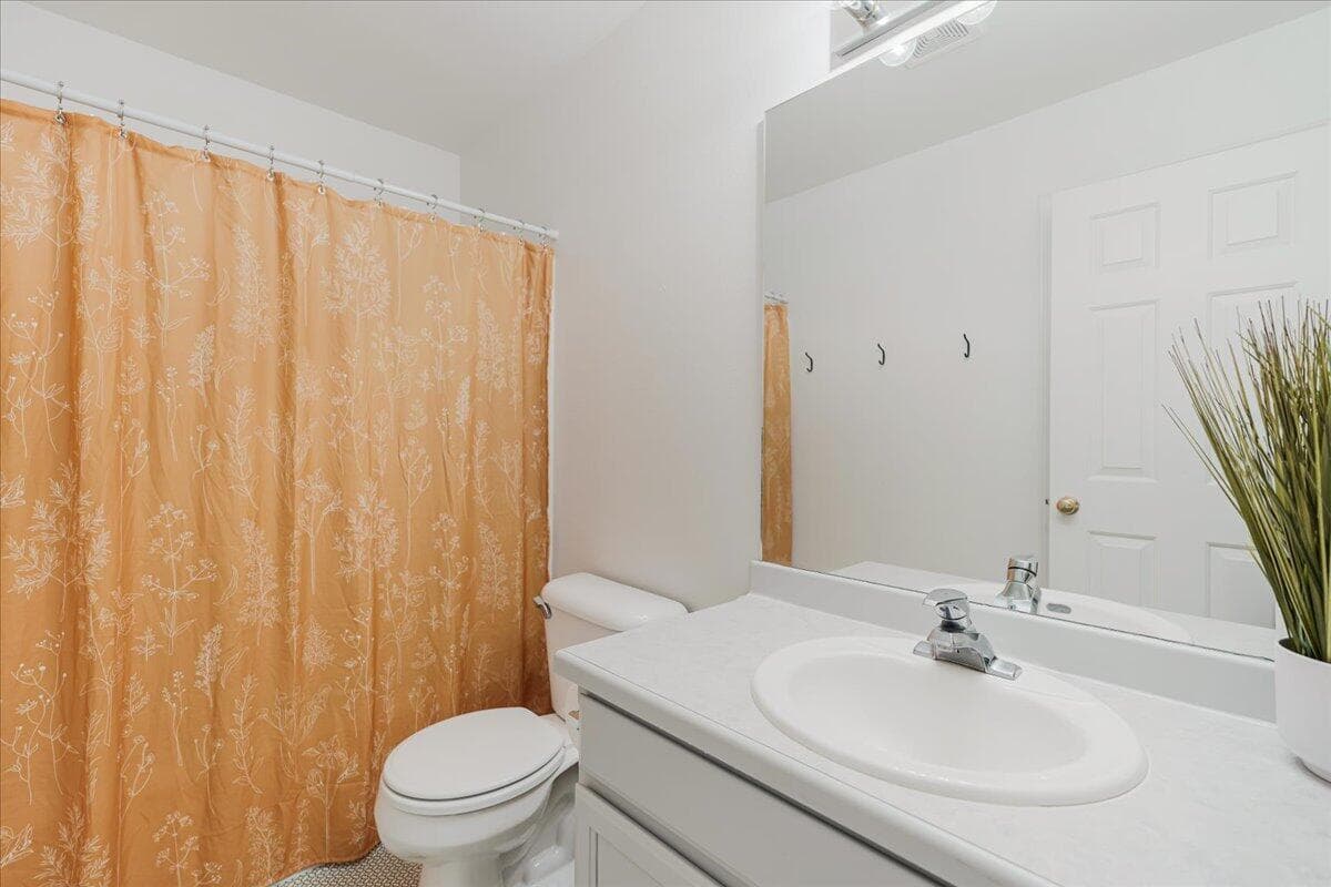 second bathroom with tub and large linen storage
