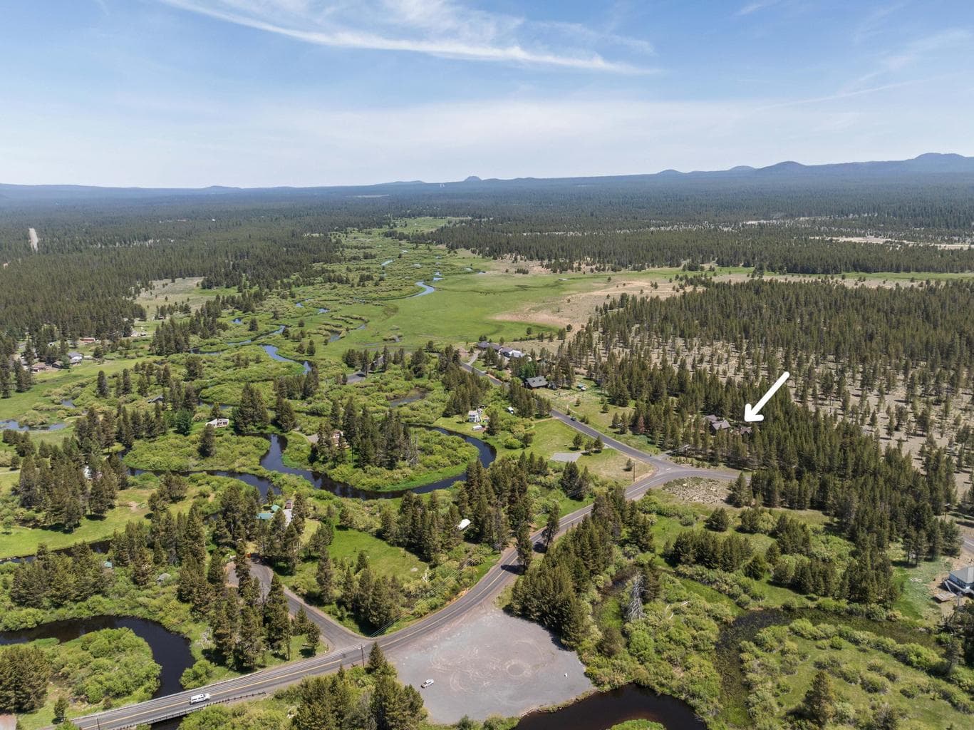 Aerial views showcase the home’s stunning setting near the Little Deschutes River—where natural beauty surrounds you in every direction.