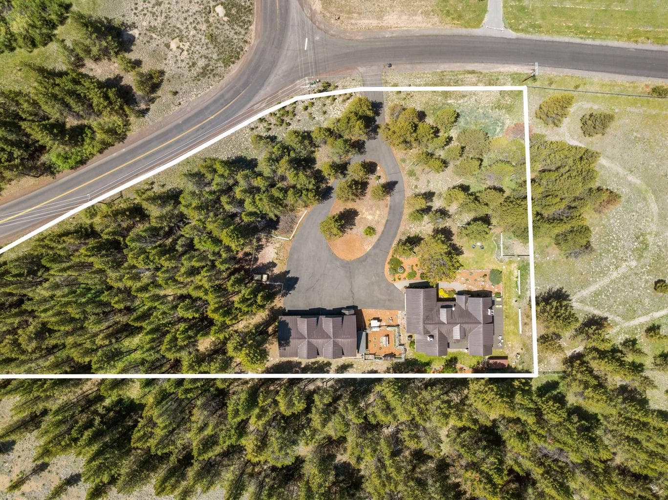Aerial view showcases the newer metal roof and highlights additional property boundaries—offering a full picture of this impressive estate. Write your offer today!