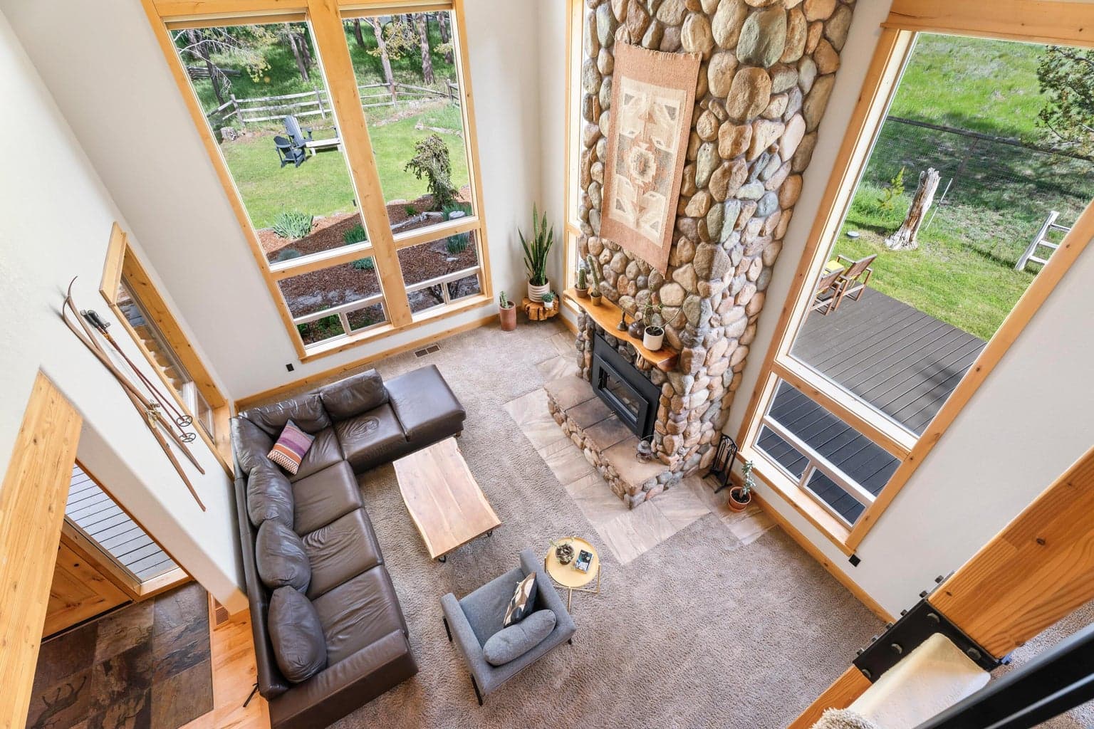 Loft railing overlooks the soaring great room below—offering dramatic views and a sense of spacious elegance.