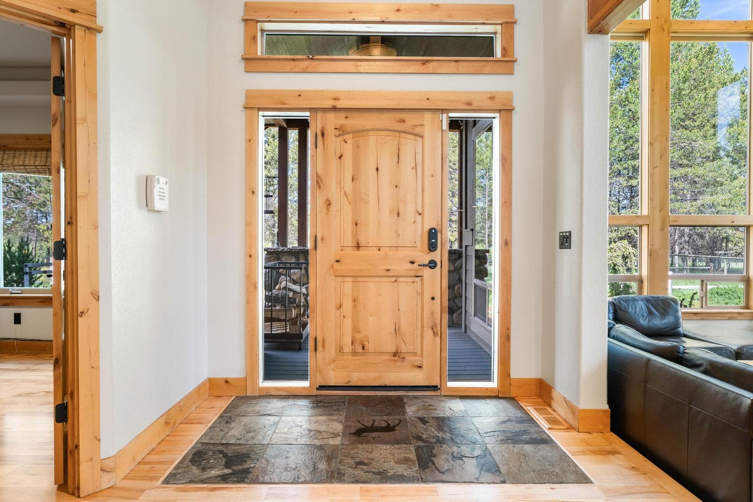 Step through a striking oversized entry door onto elegant stone flooring—a warm and impressive welcome every time you come home.
