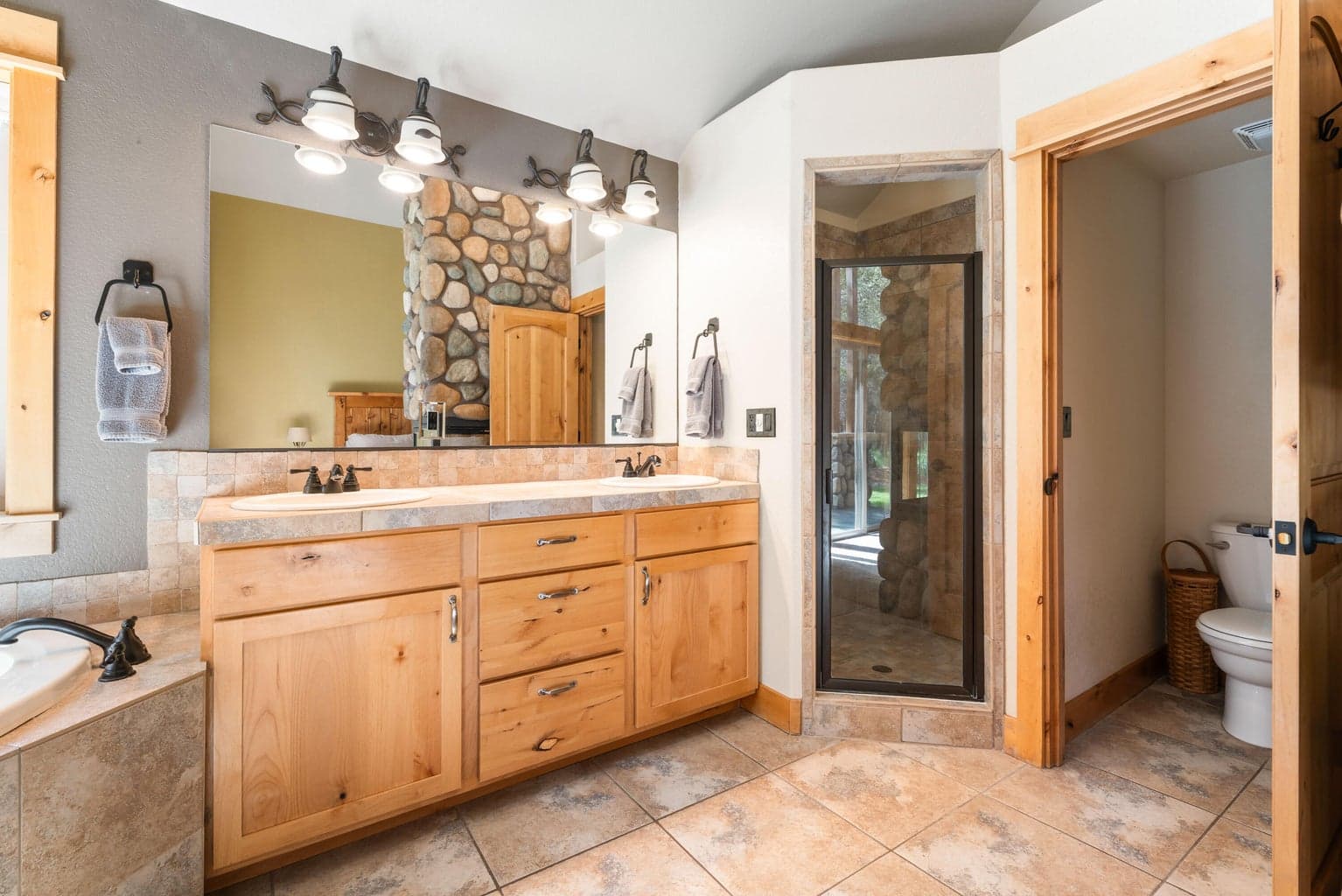 Indulge in the spa-like primary bathroom featuring a step-in shower and a deep soaking tub—your personal retreat for rest and relaxation.