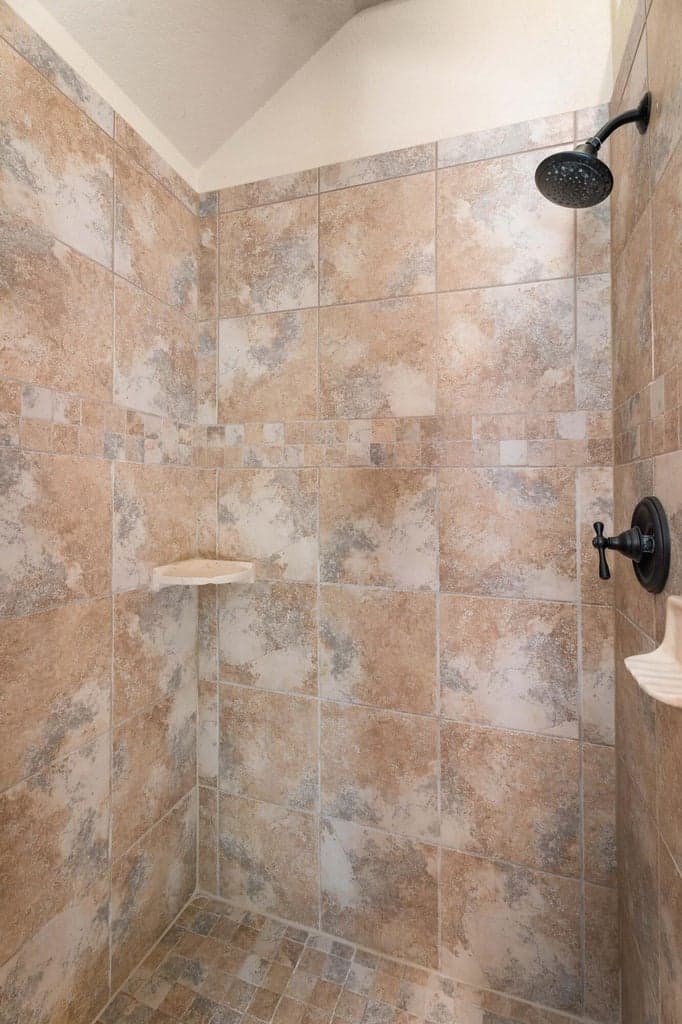 Spacious step-in shower offers both comfort and convenience—designed with style and ease in mind.