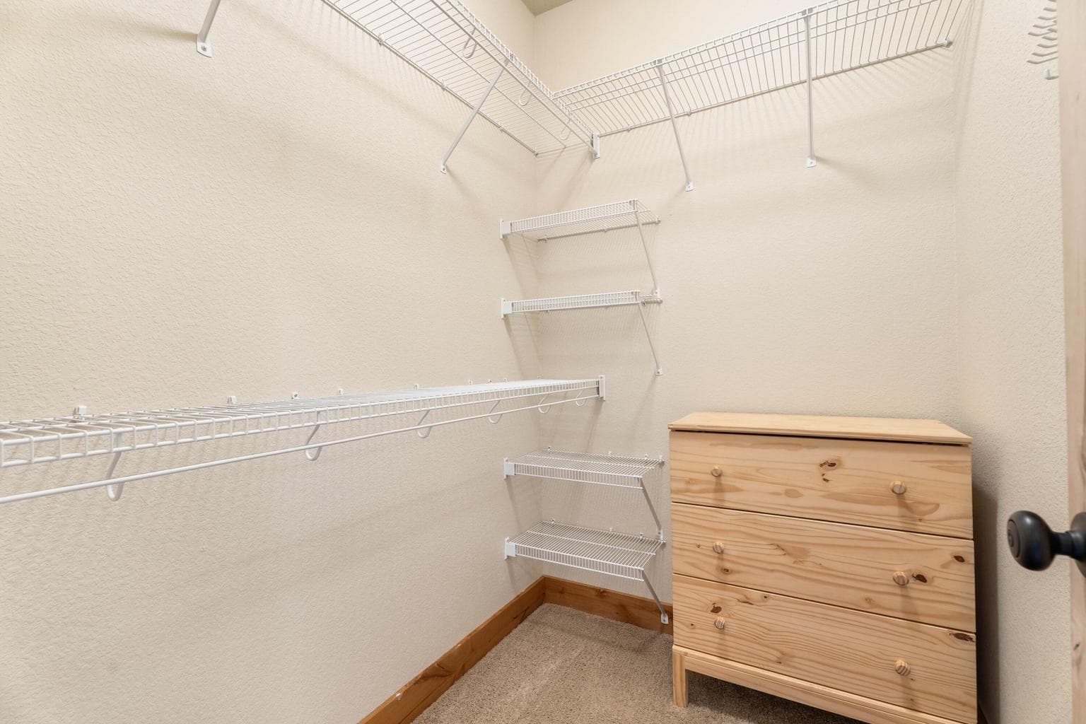 A soaring walk-in closet with ample space to organize, store, and showcase your wardrobe in style.