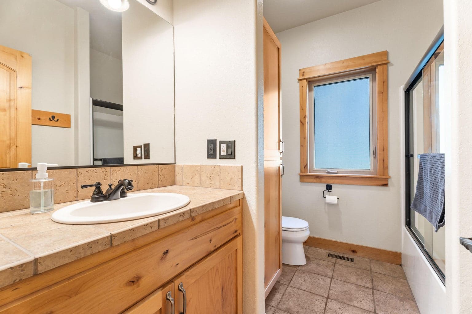 Main floor bathroom features a convenient shower/tub combo—perfect for guests or everyday use with style and function combined.
