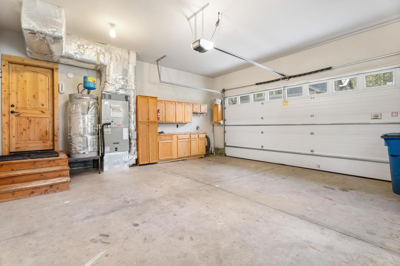 Oversized attached garage offers ample space for vehicles, storage, and essentials—complete with HVAC, water heater, and more, all conveniently tucked away.