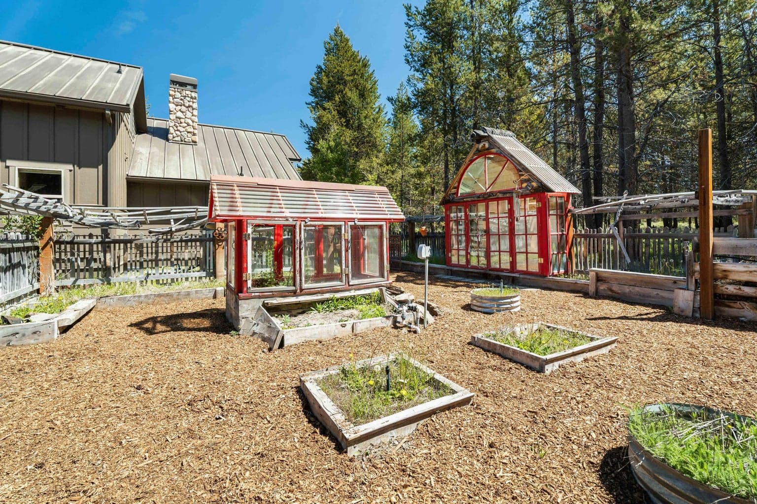 The garden is thoughtfully designed with multiple garden boxes, greenhouses, and prep areas—everything you need to cultivate and create with ease.
