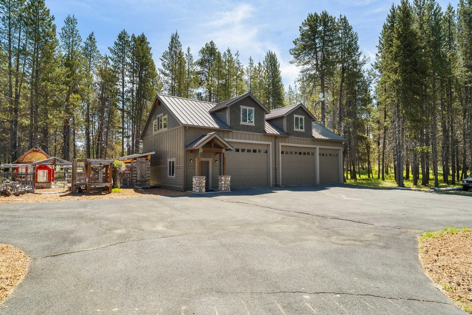 A spacious driveway leads to the impressive 30x60 ft. 3-bay garage—plenty of room for vehicles, storage, and all your gear.