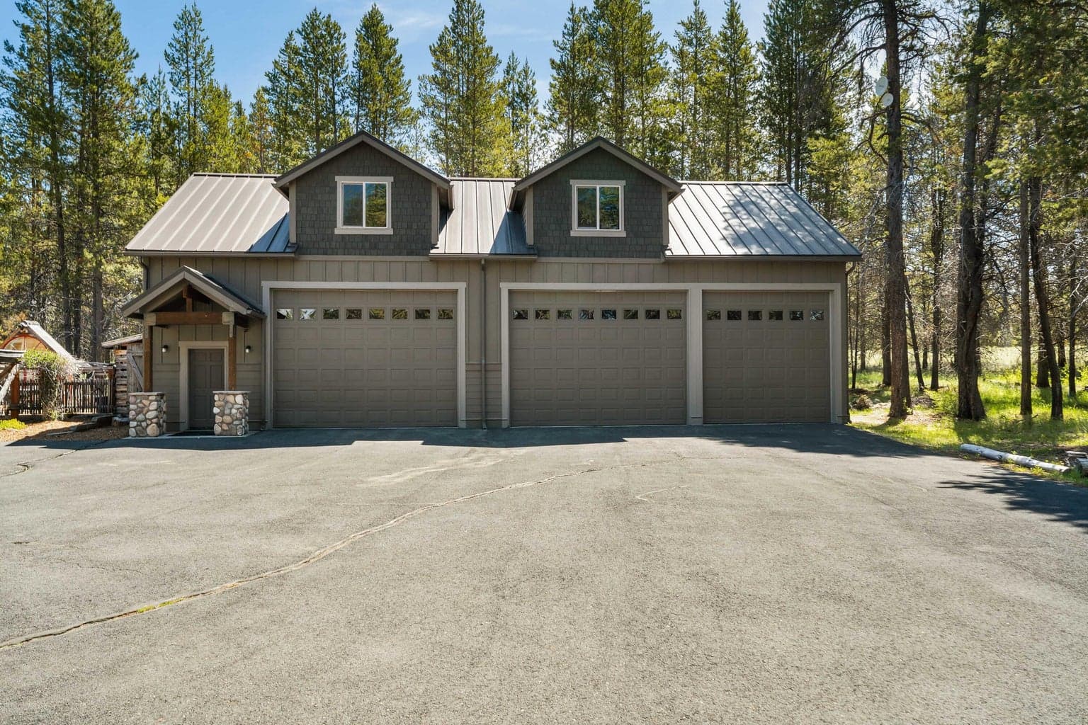 Massive garage with tall bay doors—spacious enough to fit multiple RVs, plus nearly finished living space upstairs ready for your vision.