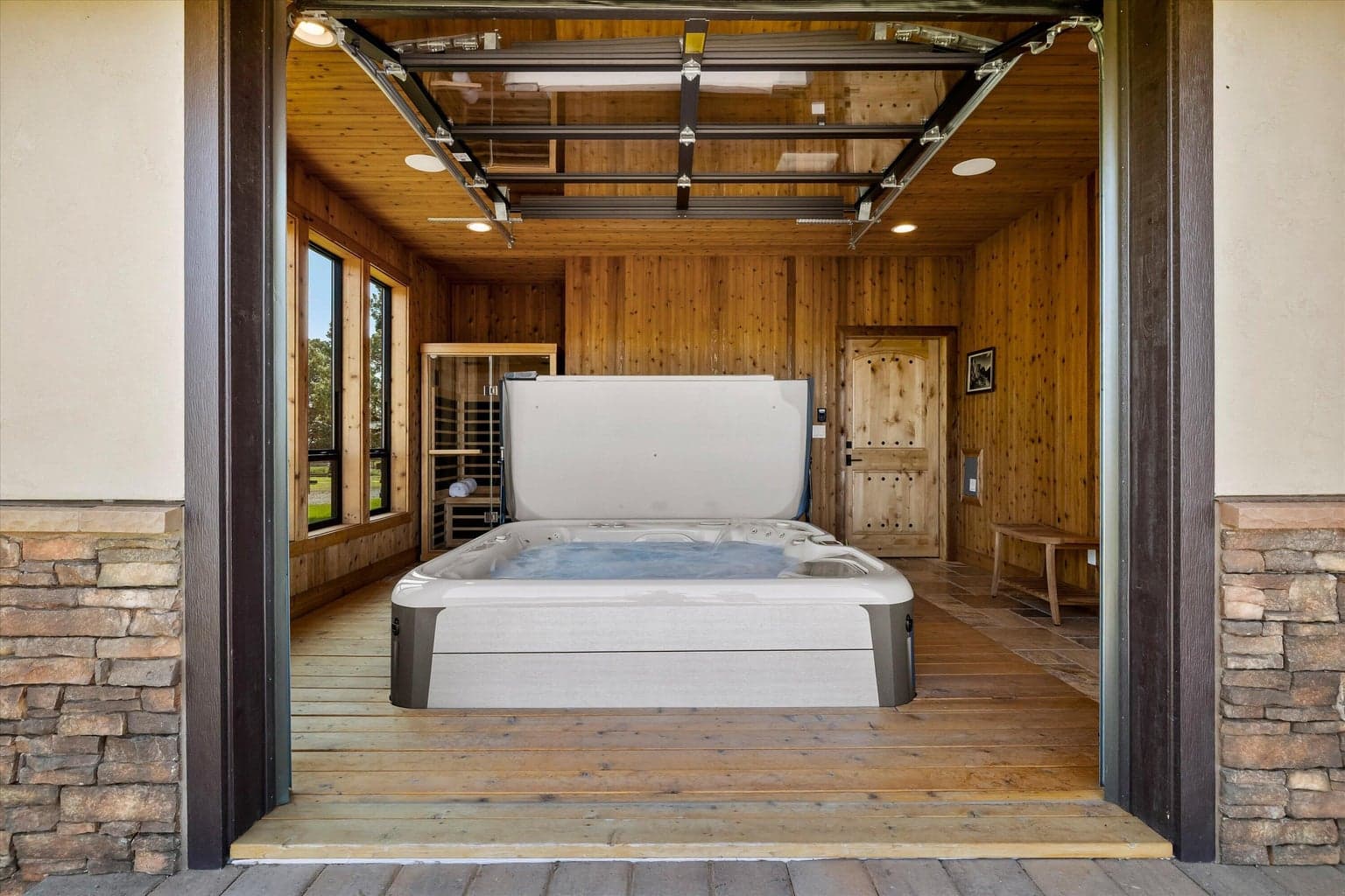 Indoor hot tub room has garage door to the outside