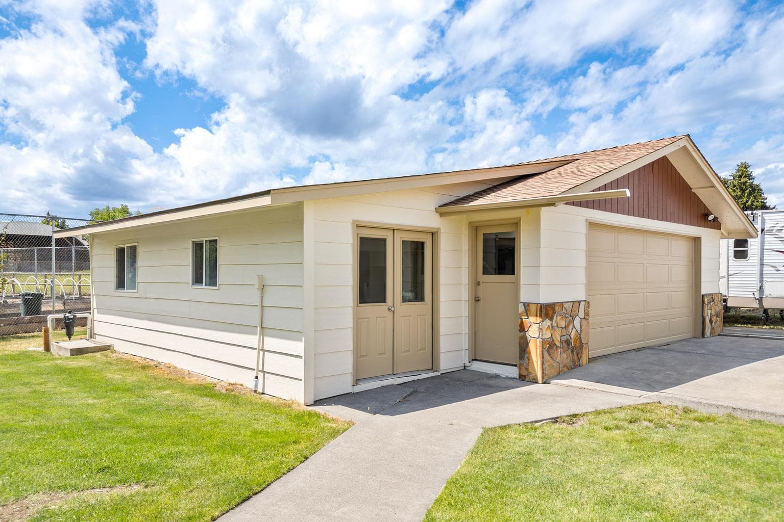 Shed adjacent to 2 car garage