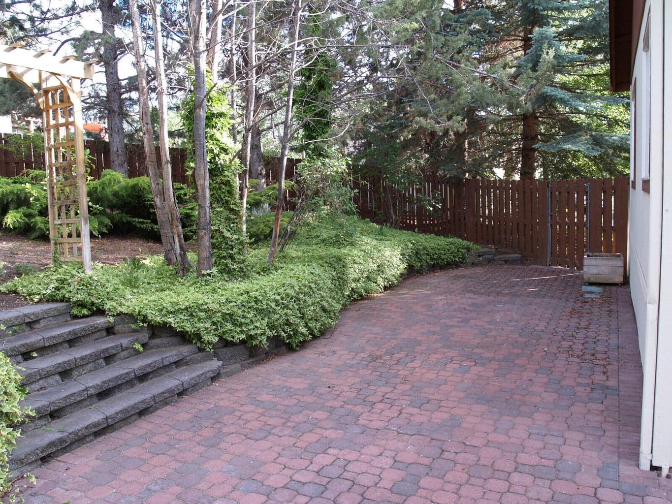 Paver patio on south side of home, gate out to front yard