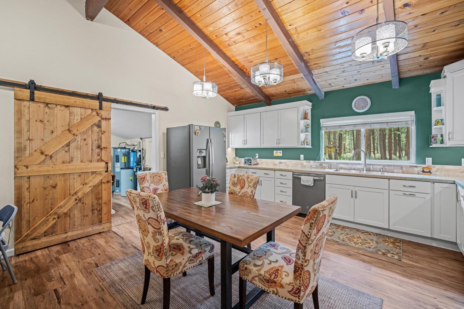 Sliding rustic barn door to the spacious laundry room with lots of additional storage