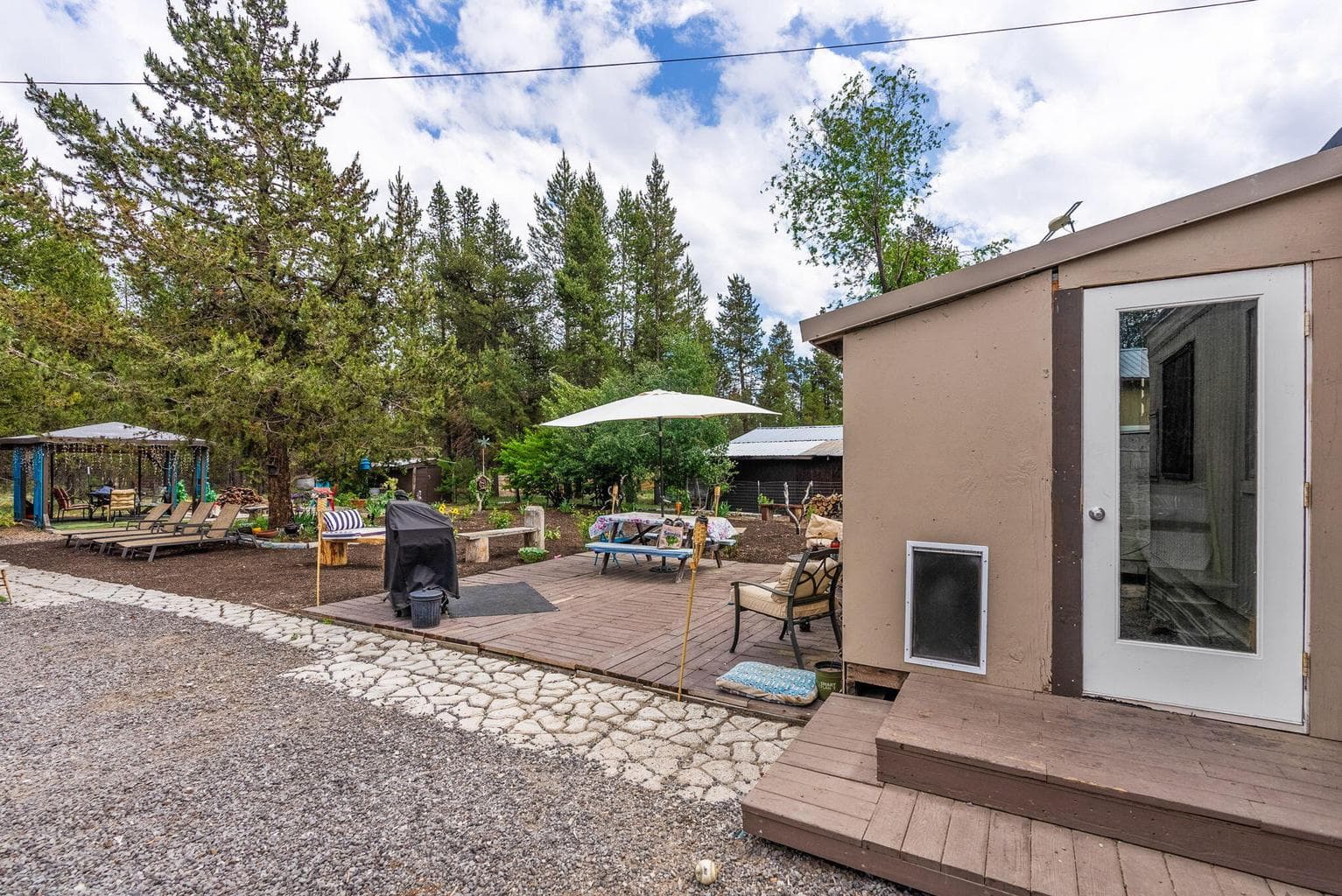 Unattached/enclosed Back porch/Mudroom. Back yard.