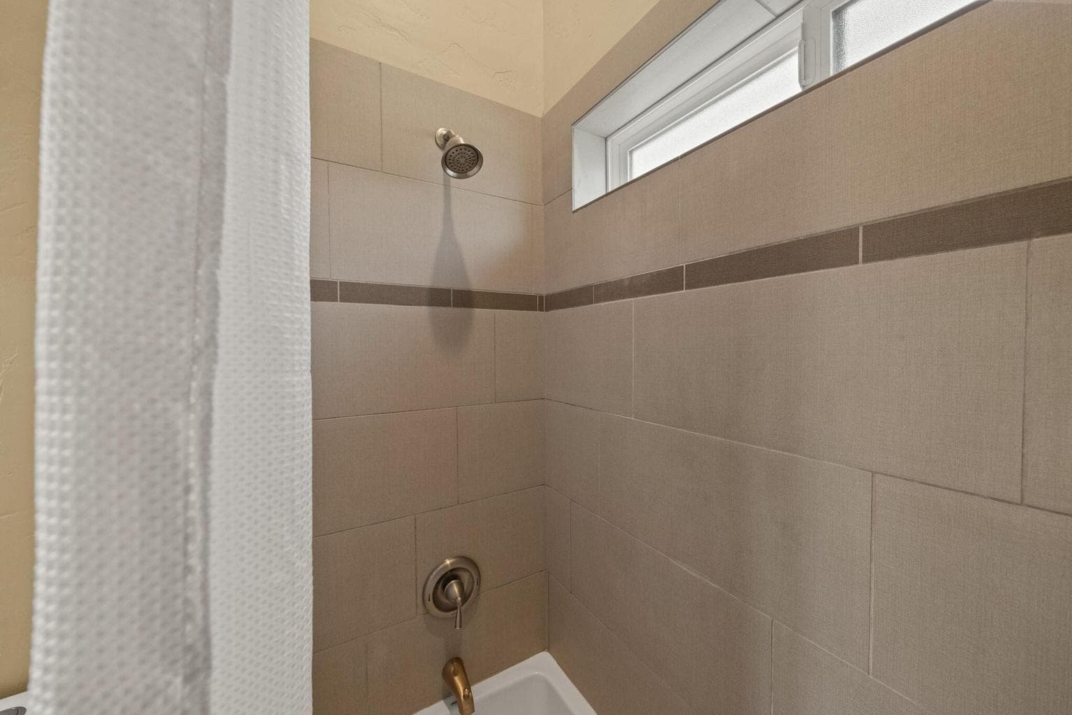 Upstairs shower, full tile + tub