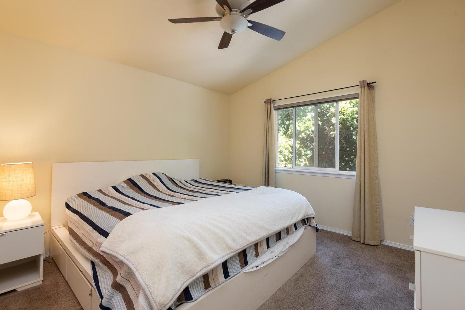 Vaulted ceiling and ceiling fan in primary suite (Bedroom #1)