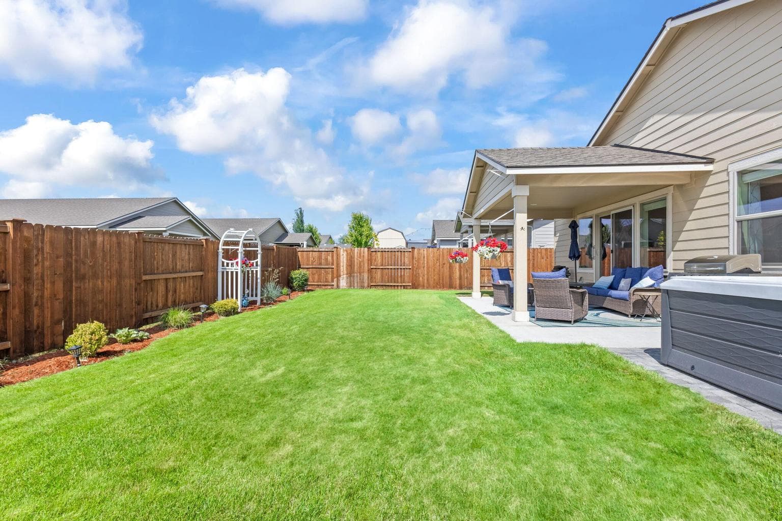Covered patio overlooking the spacious backyard