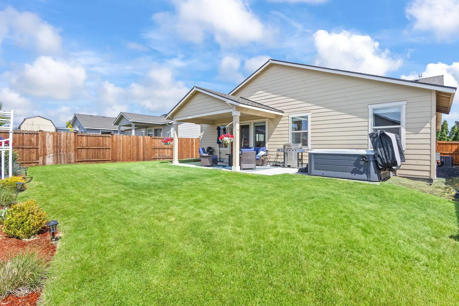 Covered patio overlooking the spacious backyard