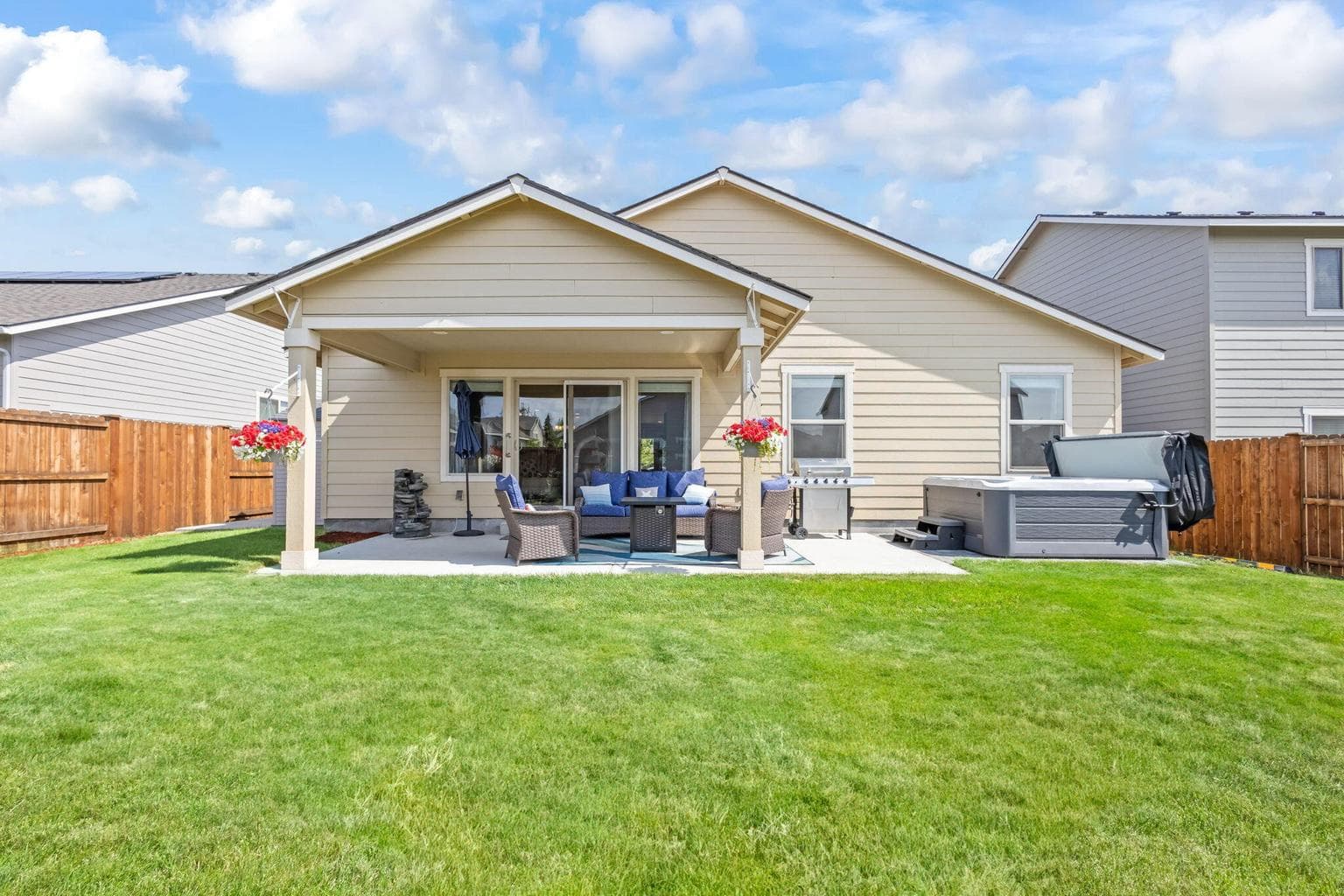 Covered patio overlooking the spacious backyard