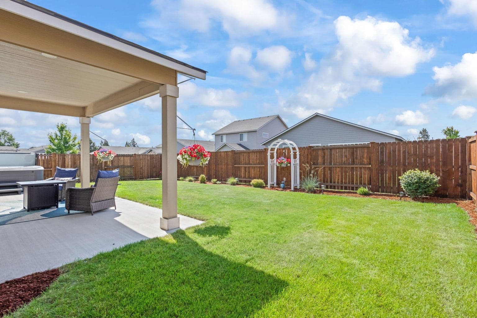 Covered patio overlooking the spacious backyard