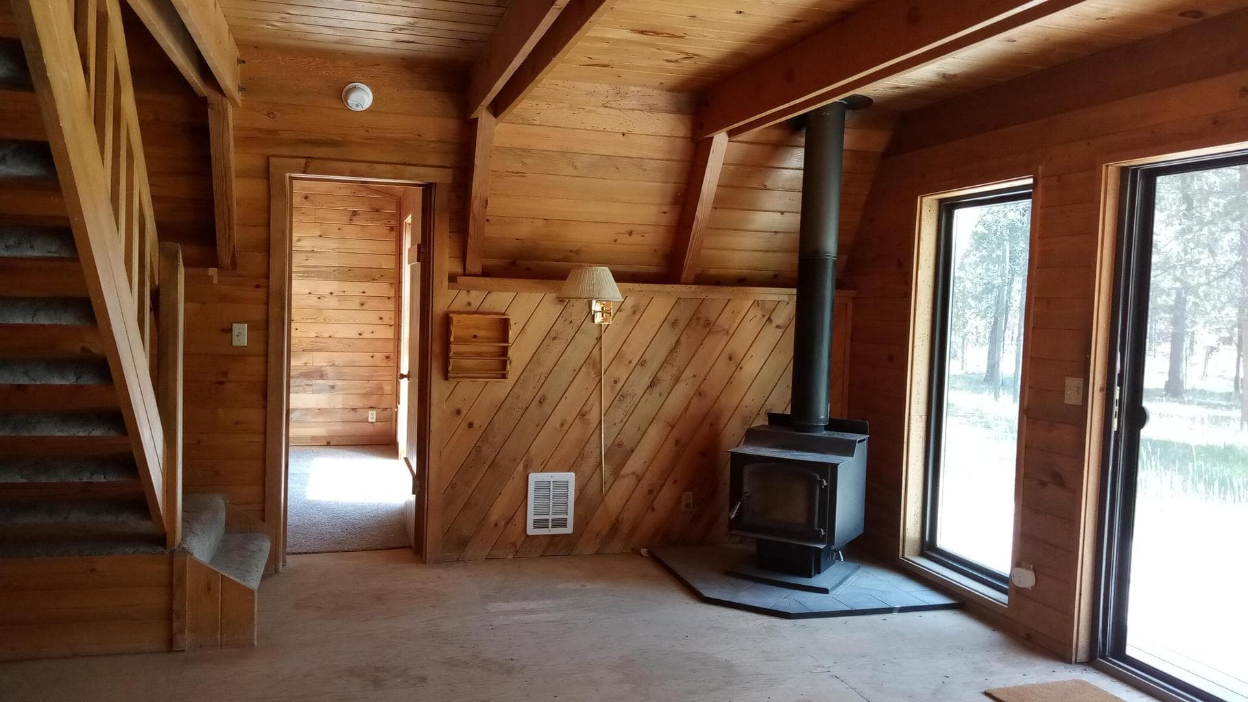 Great room w/wood stove and sliders to deck