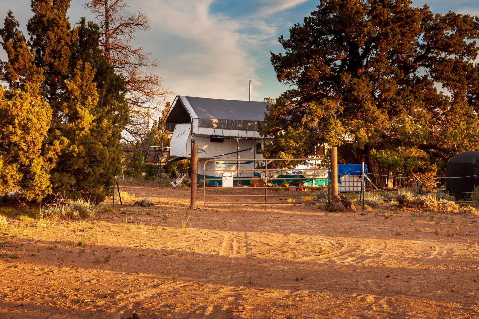 The area around the 5th Wheel RV in the center of the lot is loosely fenced & gated.