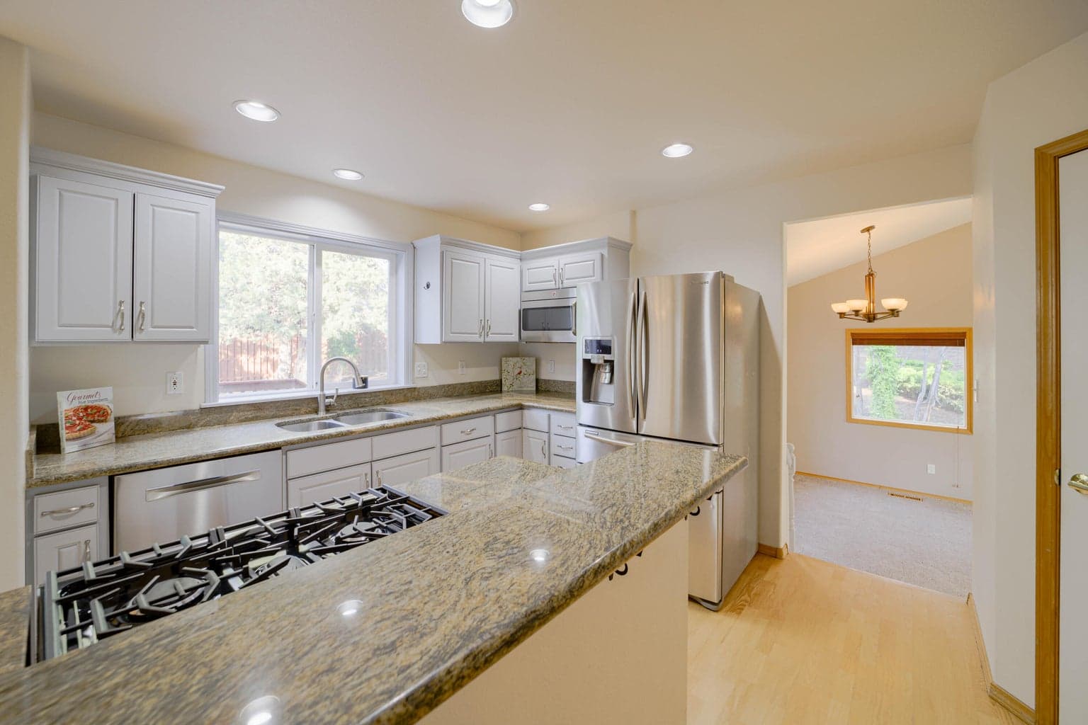 Solid granite counters, stainless appliances & hardwood in the kitchen