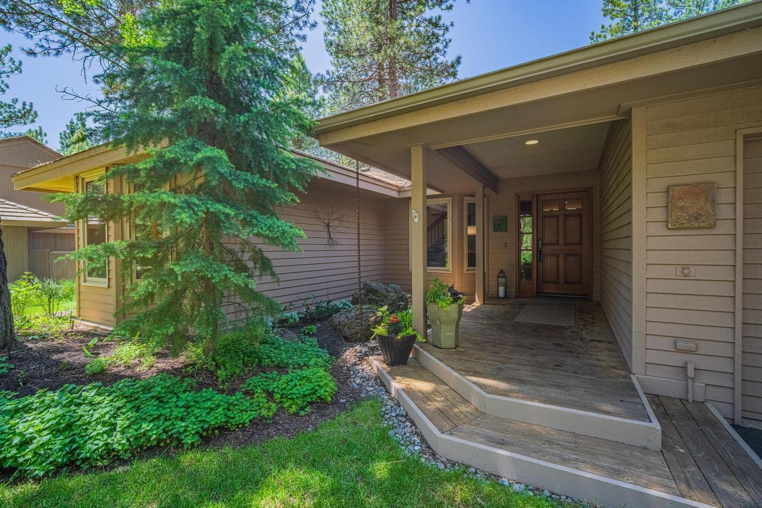 Covered entrance way and front deck at 6 Shadow lane.