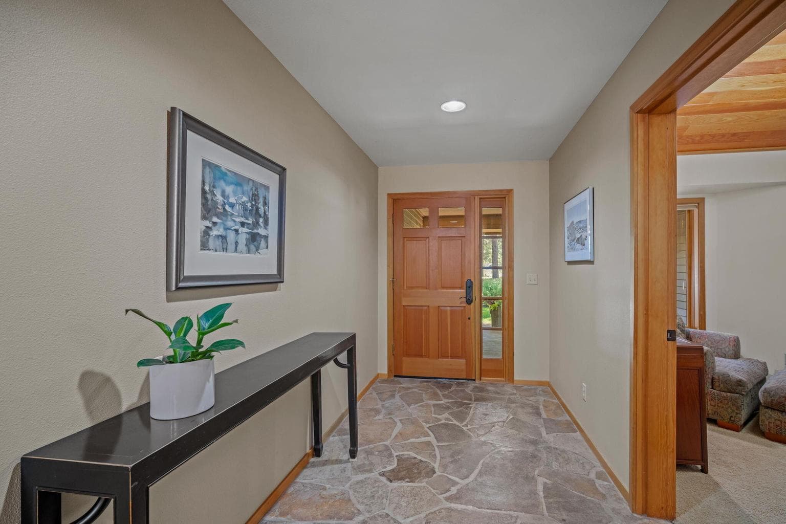 Front entry way, featured here from the inside with a wide, slate hallway.