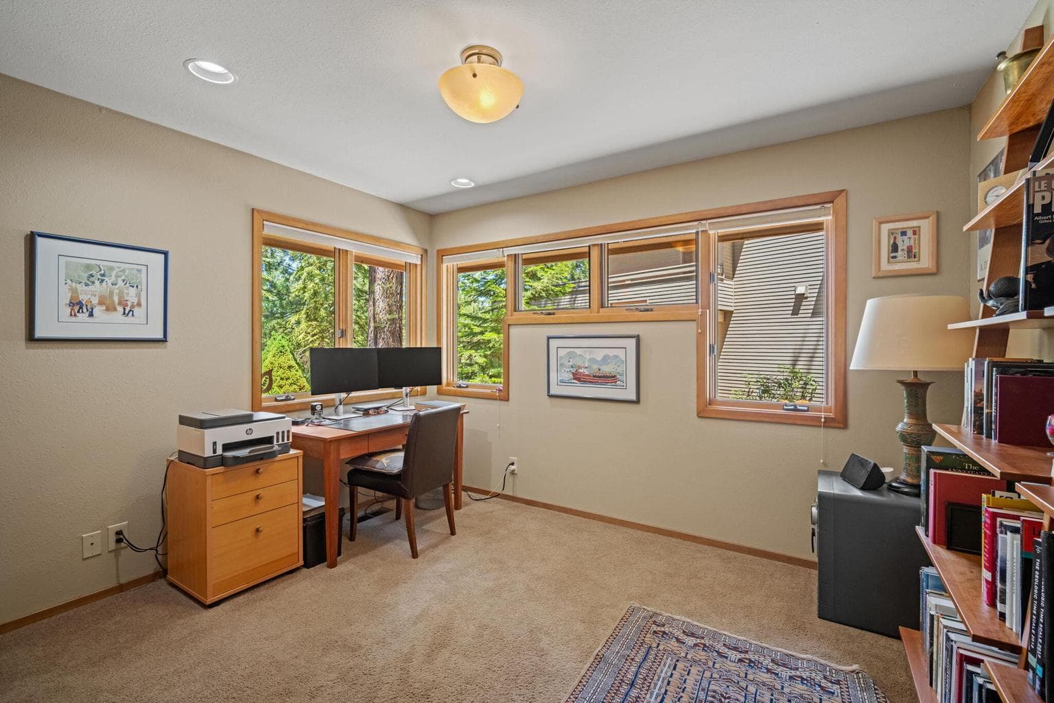 One of three bedrooms located on the main level, staged here as a home office and closet has built in shelving and drawers.