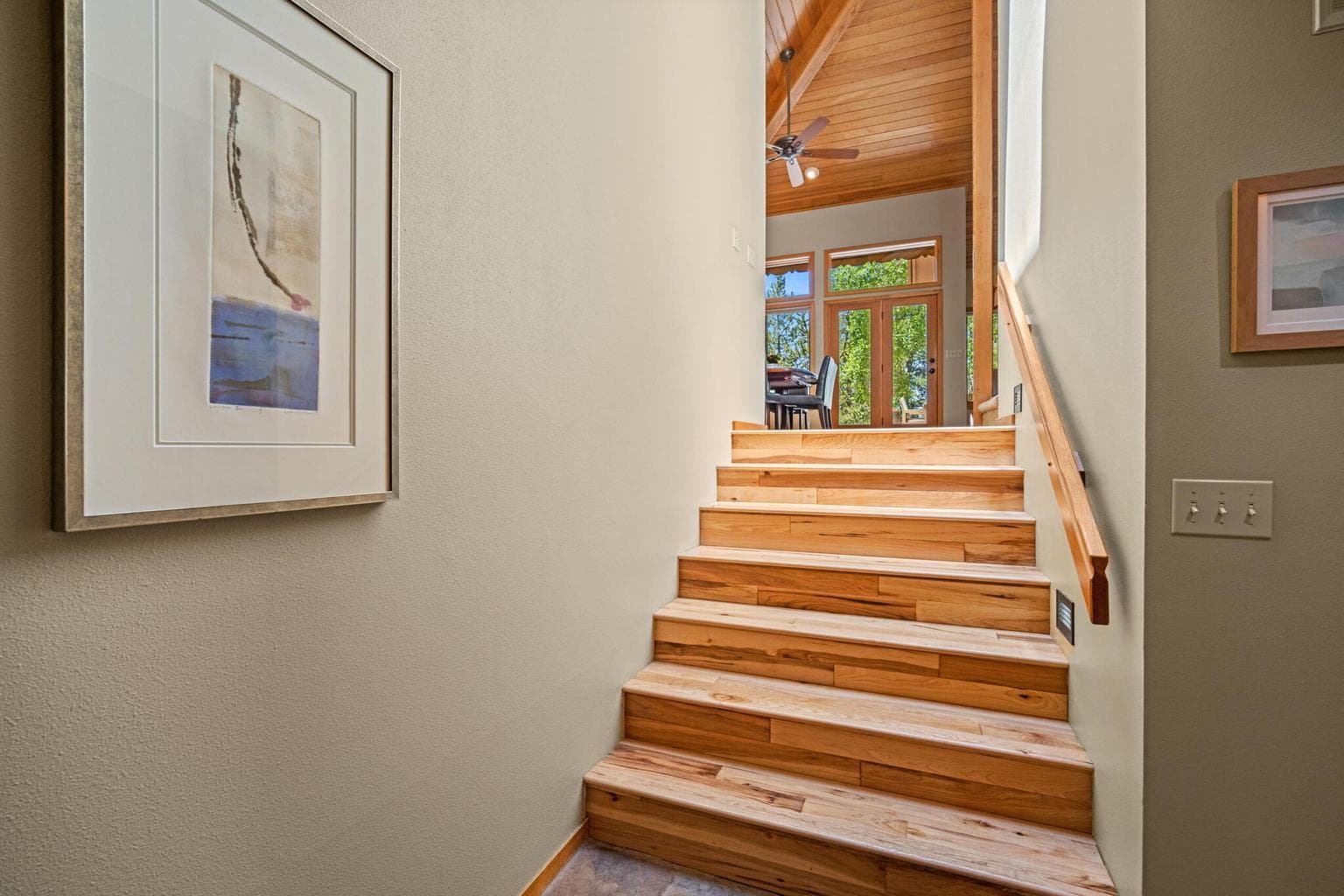 Stairs from the main entry hallway up to the great room.