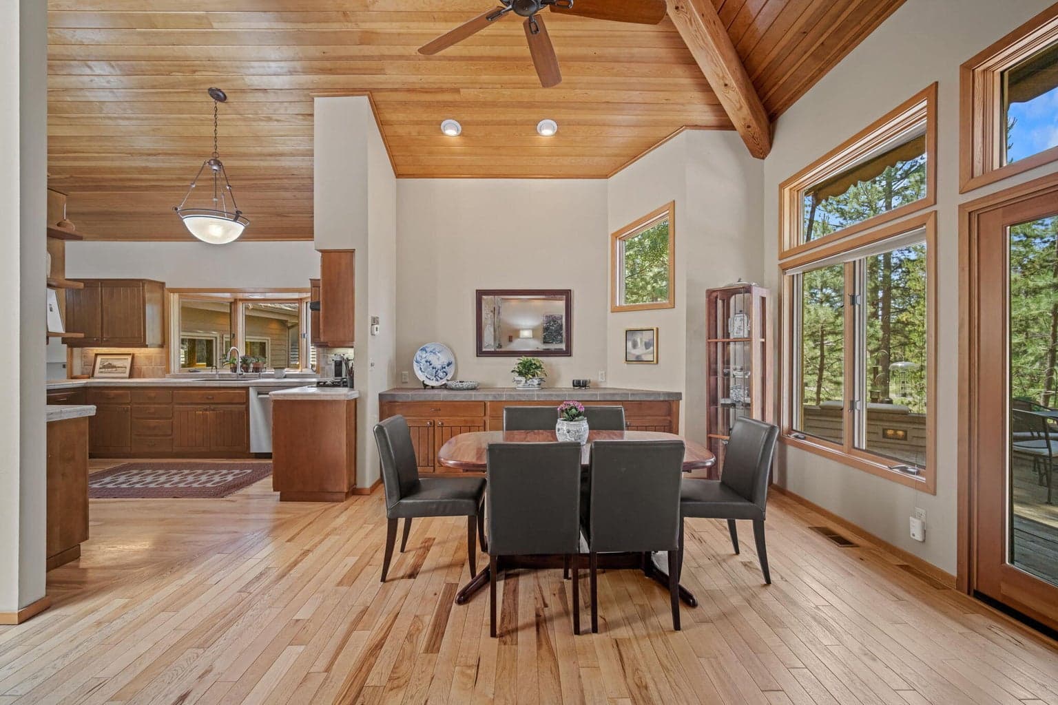 Built-in buffet frames the back wall of the dining area, bathed in natural light from west facing windows to the outdoors.