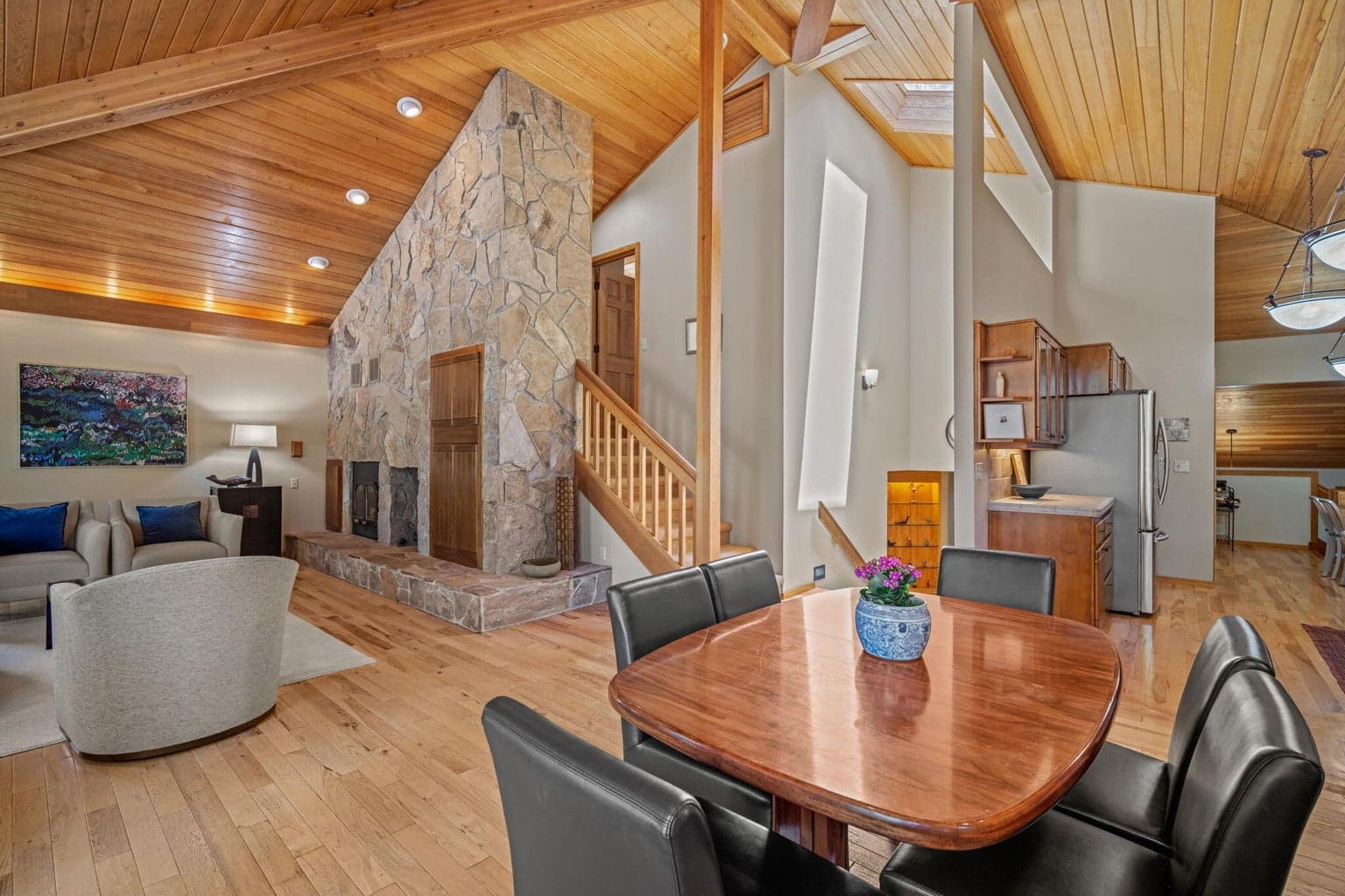 Take in the expansiveness of this beautiful great room with natural textures of wood, stone and light.