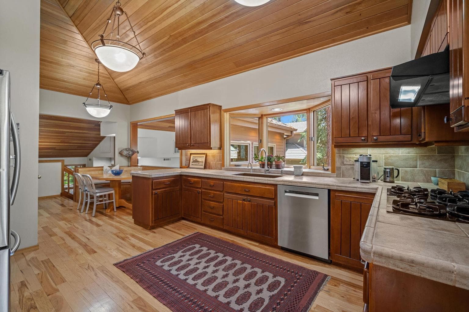 Spacious kitchen with adjoining banquette for gourmet cooking and family meals.