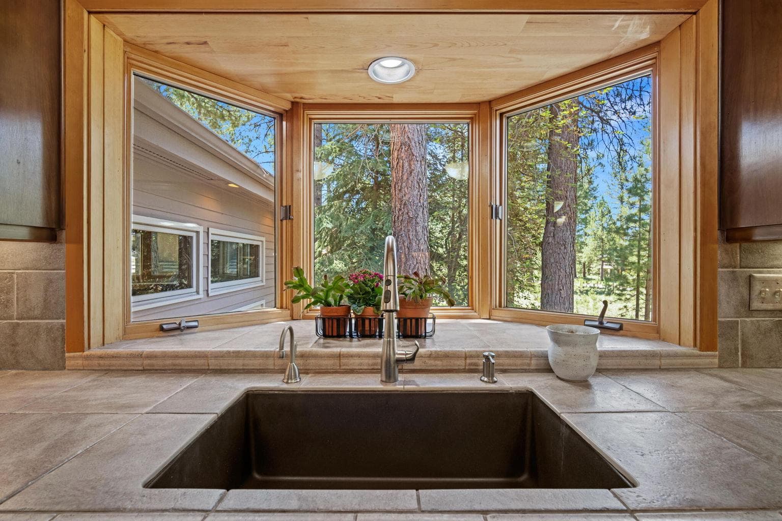 Undermount sink, tile countertops and the best view to enjoy while doing the dishes.
