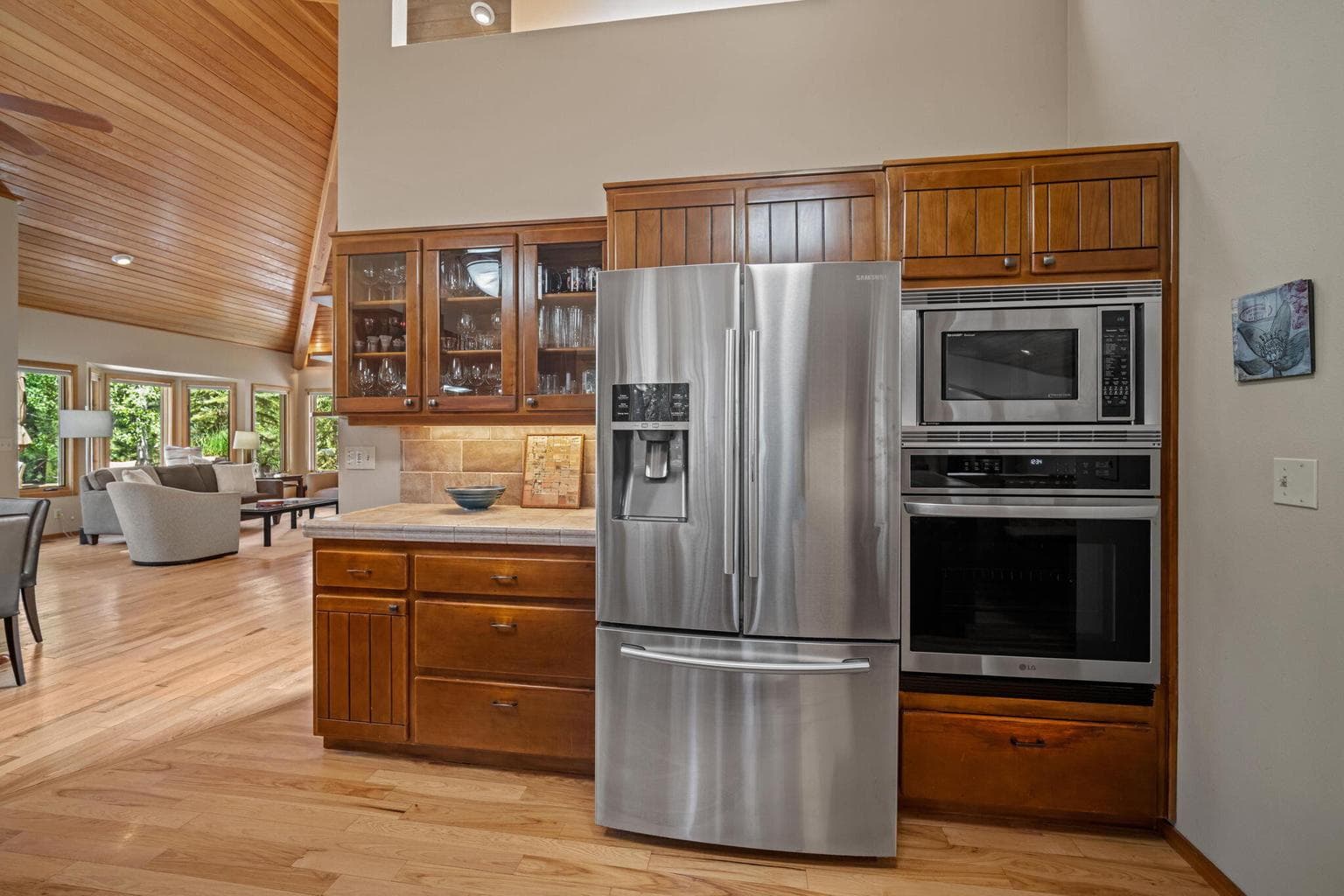Featured here, a kitchen view of the stainless steel appliances of refrigerator, microwave and oven.