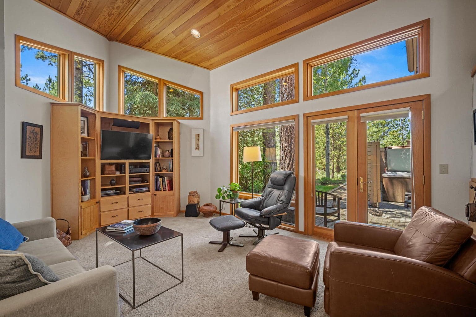Lots of windows let in the blue skies of Central Oregon. Family room shown here.