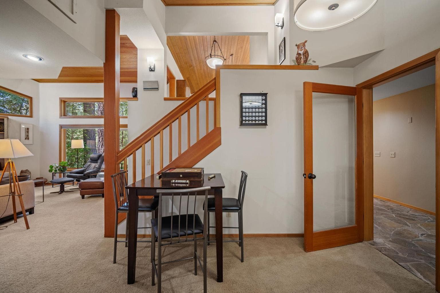 View from the main level up to the lofted kitchen banquette that looks over to the entertainment den.